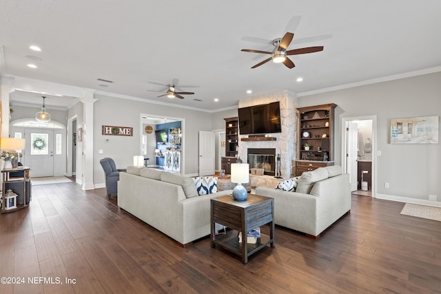 living area with dark wood-style floors, crown molding, and a fireplace