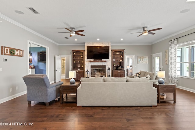 living room with visible vents, ornamental molding, dark wood-style flooring, and a high end fireplace