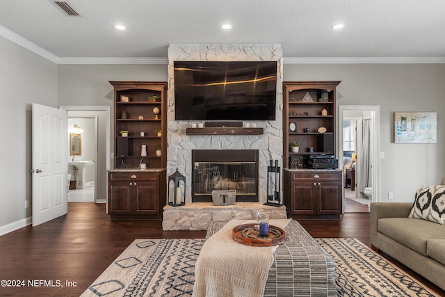 living area featuring a fireplace, visible vents, baseboards, ornamental molding, and dark wood finished floors