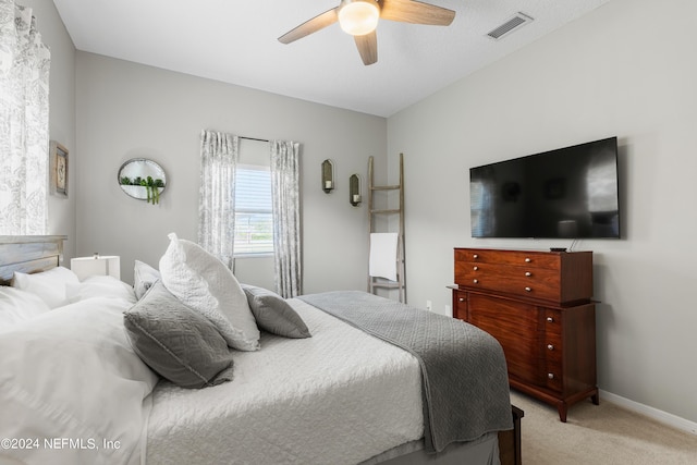 bedroom with light carpet, baseboards, visible vents, and ceiling fan