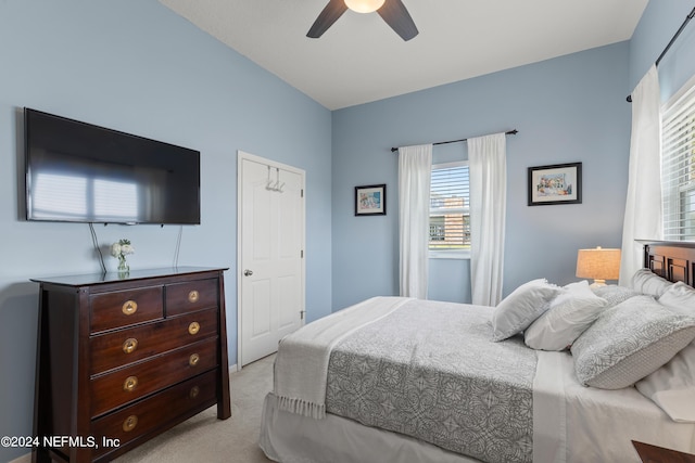 bedroom with a ceiling fan and light carpet