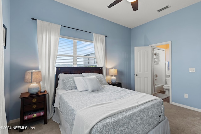 carpeted bedroom with ensuite bathroom, ceiling fan, visible vents, and baseboards