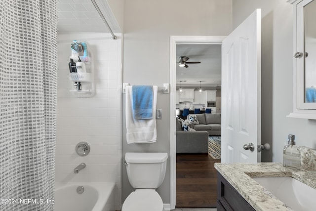 bathroom with ceiling fan, toilet, vanity, shower / bath combo, and ensuite bath