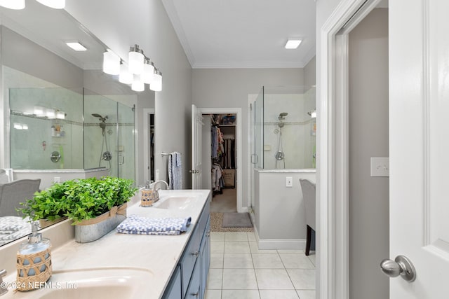 full bath with a spacious closet, ornamental molding, a sink, a shower stall, and tile patterned floors