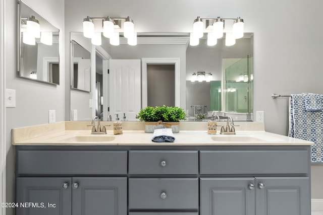 full bath with double vanity, a shower, and a sink