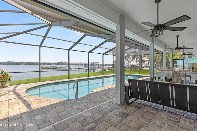 pool with ceiling fan, a patio area, a lanai, and a water view