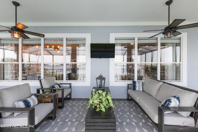 sunroom featuring ceiling fan