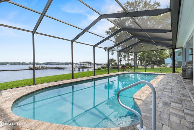 outdoor pool with a lanai, a water view, a patio, and a lawn