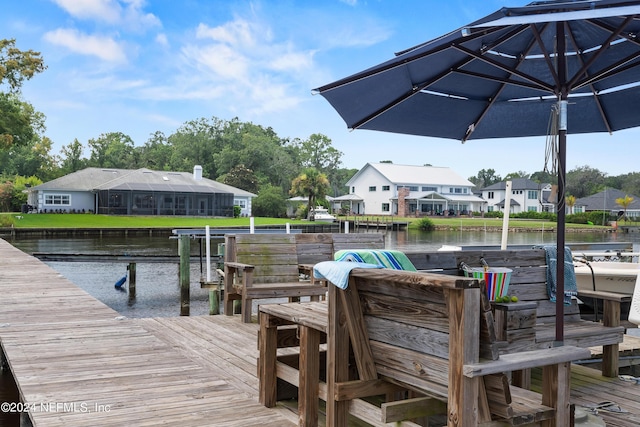 dock area with a residential view and a water view