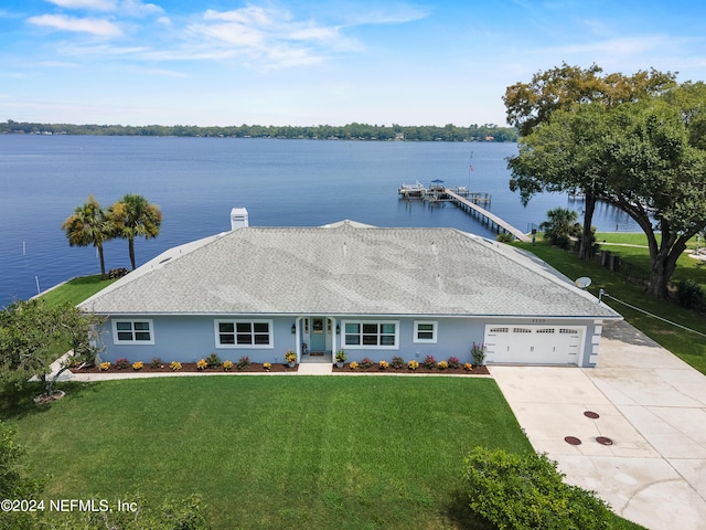 single story home featuring roof with shingles, a water view, a front yard, a garage, and driveway