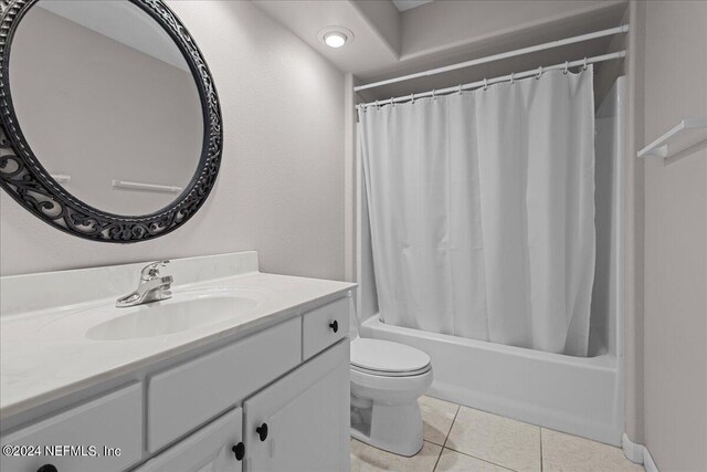 bathroom featuring toilet, vanity, and tile patterned floors