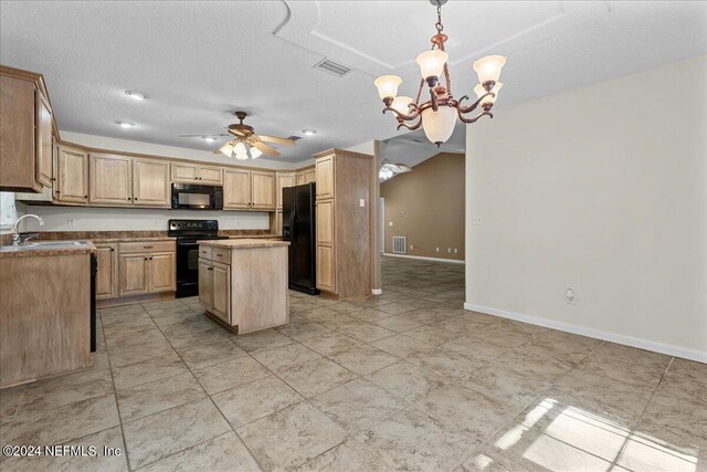 kitchen featuring a center island, black appliances, ceiling fan with notable chandelier, sink, and hanging light fixtures