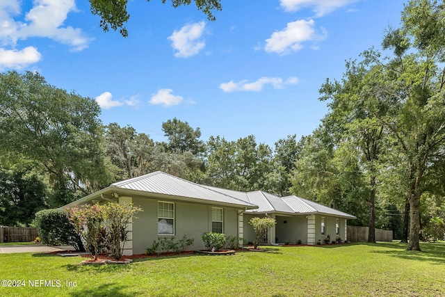 ranch-style home featuring a front yard