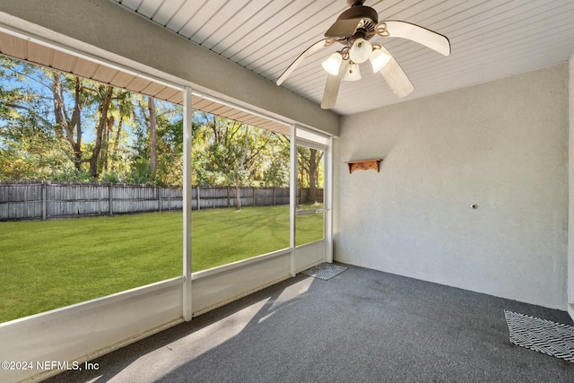 unfurnished sunroom with ceiling fan