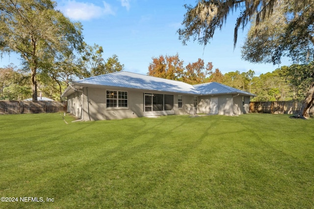 rear view of house featuring a yard