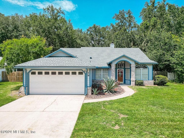 single story home with brick siding, an attached garage, fence, driveway, and a front lawn