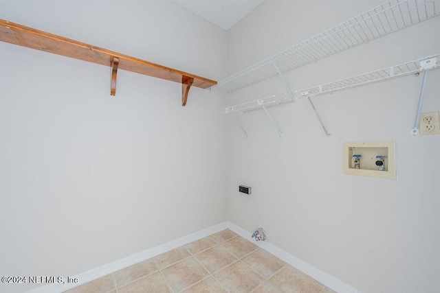 washroom featuring light tile patterned flooring, hookup for an electric dryer, hookup for a gas dryer, and hookup for a washing machine