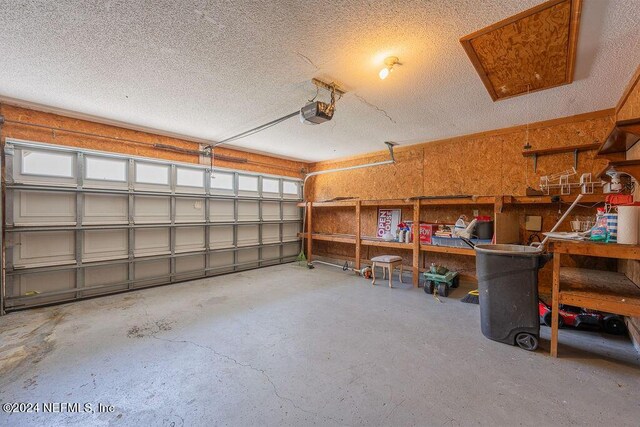 garage featuring a garage door opener and a workshop area