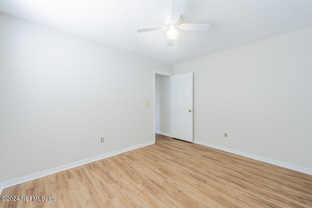 spare room with light hardwood / wood-style floors and ceiling fan