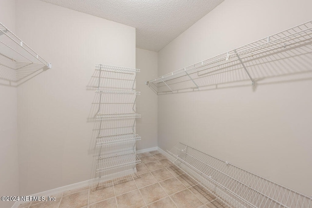 spacious closet featuring light tile patterned floors