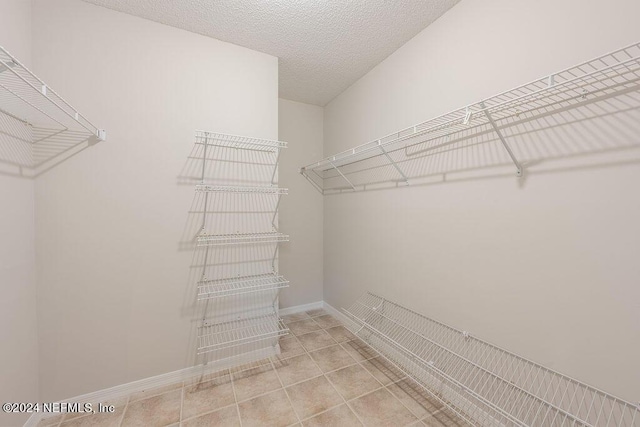 walk in closet featuring tile patterned flooring