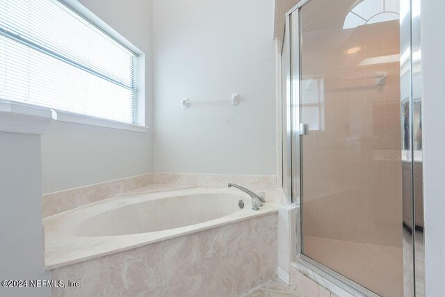 bathroom with shower with separate bathtub