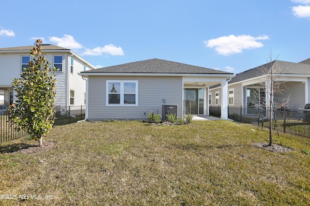 back of property featuring ceiling fan, a yard, and central AC unit