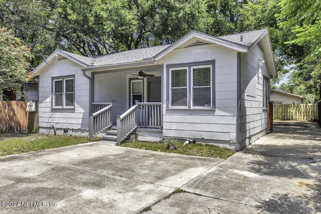 view of front of home featuring ceiling fan, covered porch, fence, crawl space, and roof with shingles