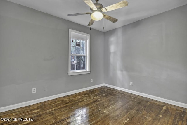 empty room with a ceiling fan, baseboards, and dark wood-style flooring