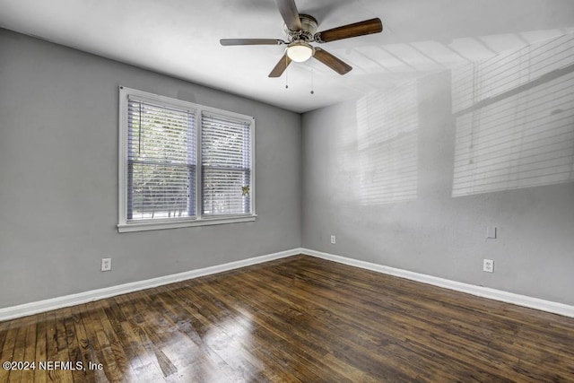 unfurnished room with ceiling fan, wood finished floors, and baseboards