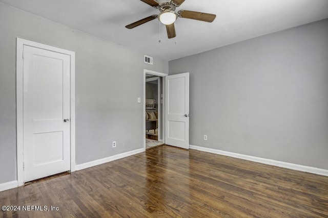 unfurnished bedroom featuring baseboards, visible vents, ceiling fan, and wood finished floors