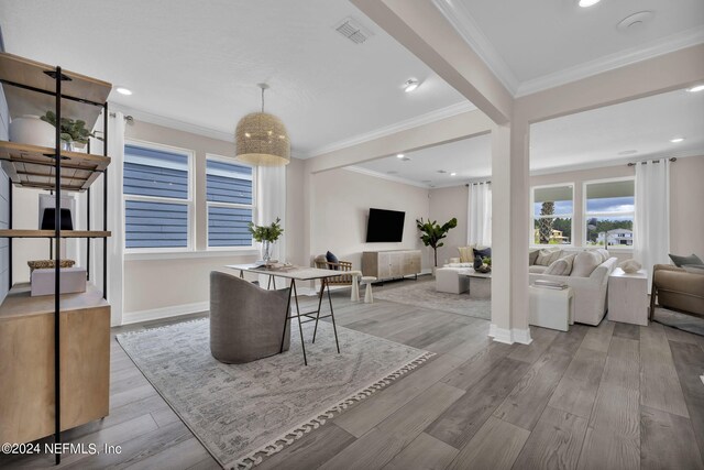 dining room featuring light hardwood / wood-style flooring and ornamental molding