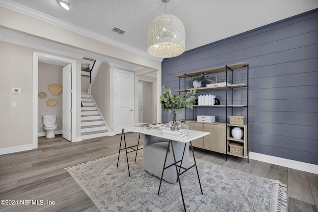 home office with hardwood / wood-style flooring and ornamental molding