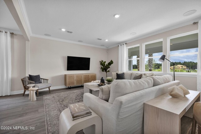 living room featuring hardwood / wood-style flooring and ornamental molding