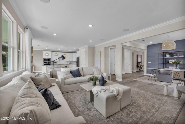 living room with hardwood / wood-style floors and ornamental molding