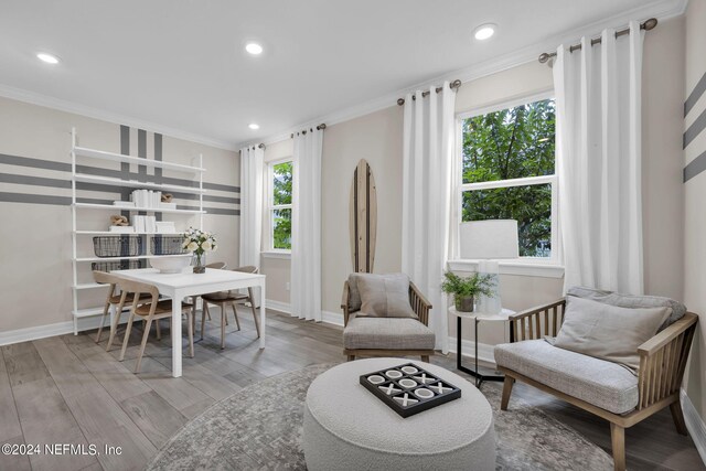 dining area featuring light hardwood / wood-style flooring and ornamental molding