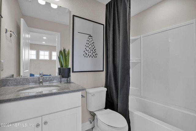 full bathroom featuring vanity, shower / tub combo, and toilet