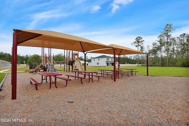 view of property's community with playground community and a lawn