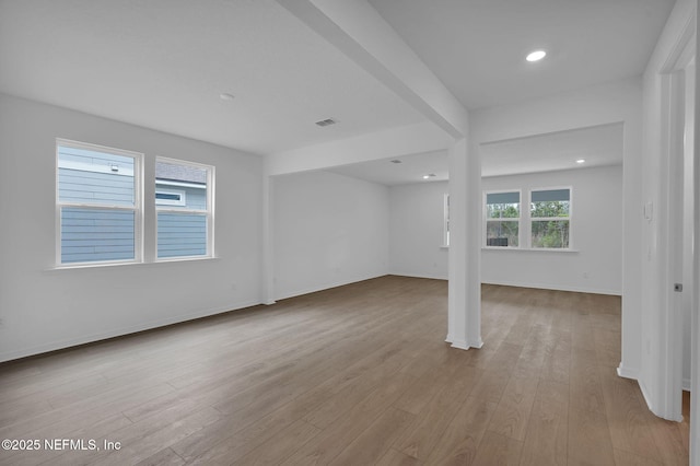 spare room with recessed lighting, visible vents, baseboards, and wood finished floors