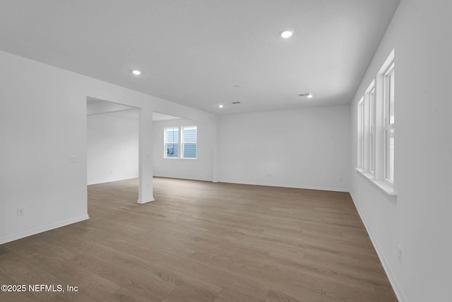 unfurnished room featuring light wood-style flooring, recessed lighting, and baseboards