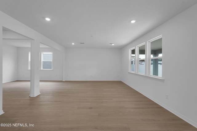 spare room featuring visible vents, recessed lighting, light wood-type flooring, and baseboards