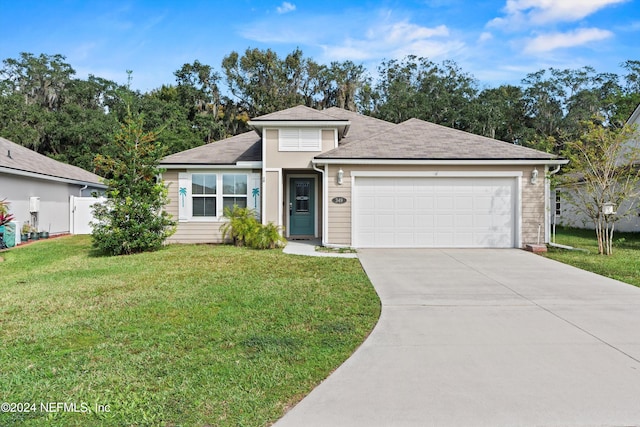 view of front of home featuring a front yard and a garage