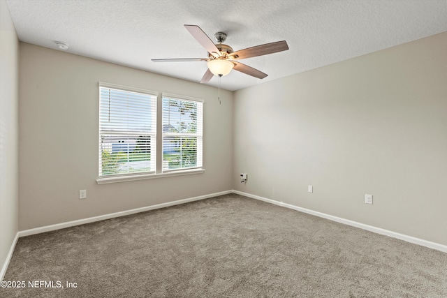 unfurnished room with ceiling fan, carpet, and a textured ceiling