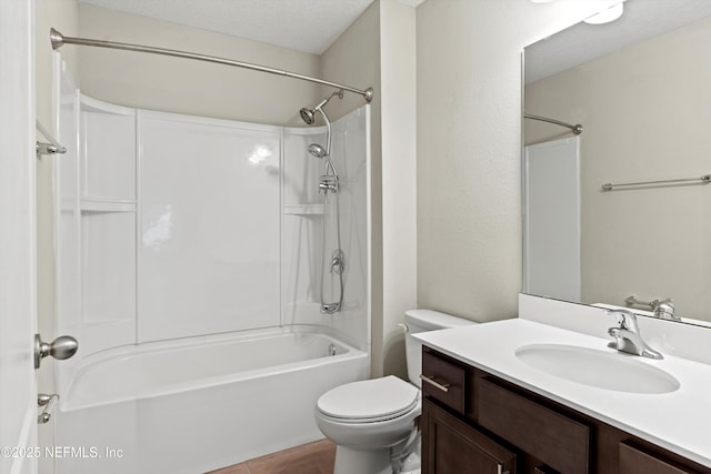 full bathroom with vanity, tub / shower combination, a textured ceiling, and toilet