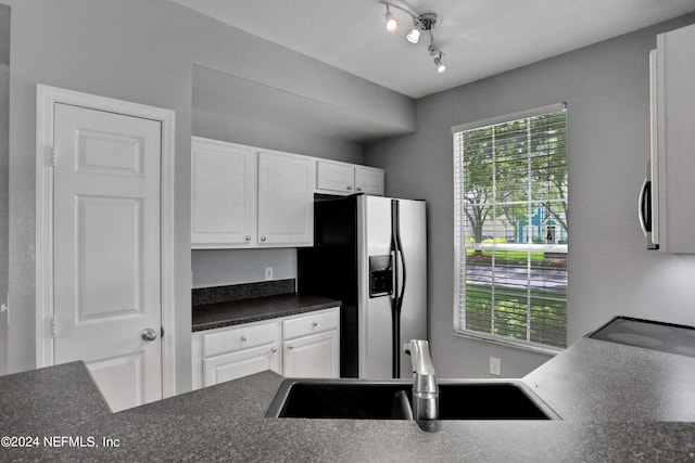 kitchen with white cabinetry, sink, and stainless steel appliances