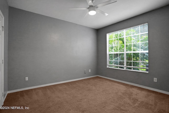 spare room featuring carpet flooring and ceiling fan