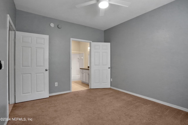 unfurnished bedroom featuring ceiling fan, connected bathroom, and light carpet