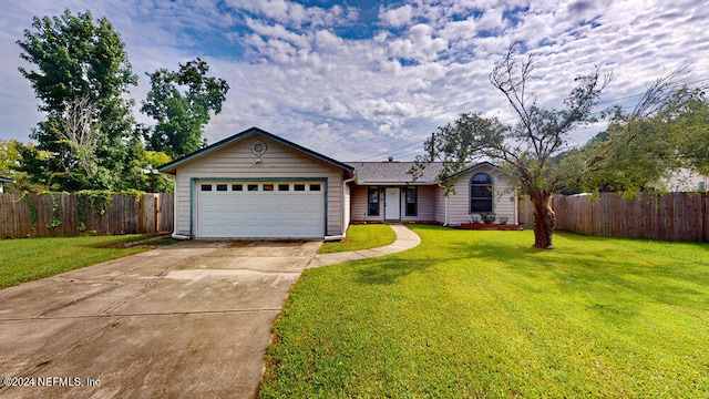 single story home featuring a garage and a front lawn