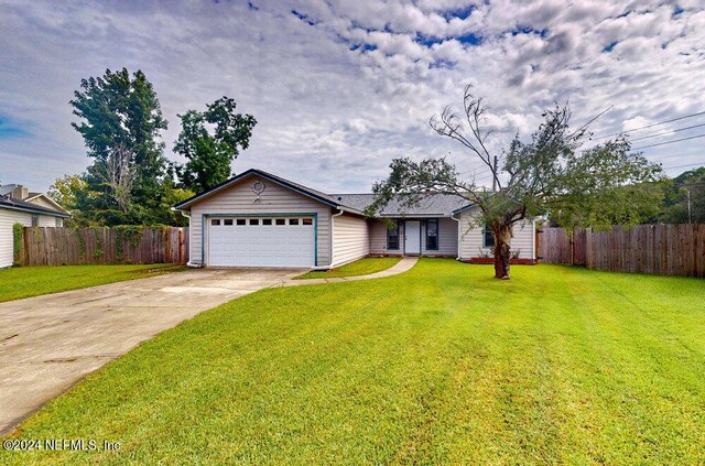 ranch-style house featuring a garage and a front yard