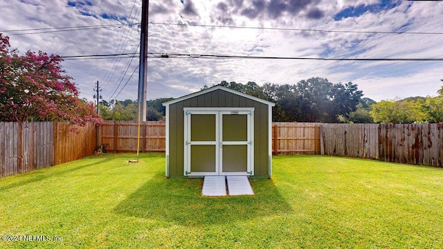 view of outdoor structure featuring a lawn